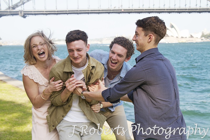 brothers and sisters tickling and having fun. Harbour views - Family Portrait Photography Sydney